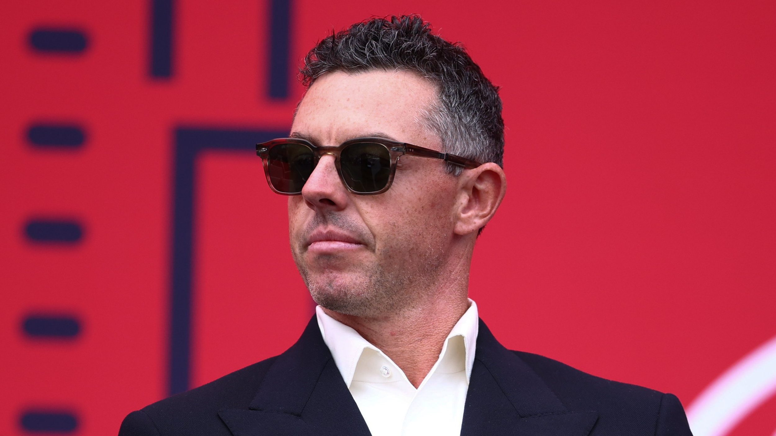 Rory McIlroy in suit and sunglasses ahead of the 2025 Ryder Cup